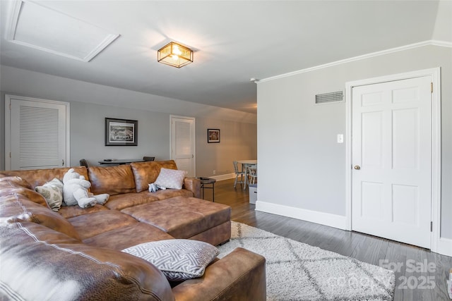 living room with ornamental molding and dark wood-type flooring