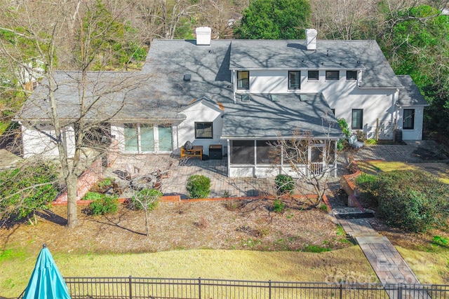 rear view of house with a patio and a sunroom