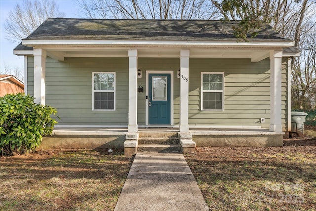 view of front of house featuring covered porch and roof with shingles