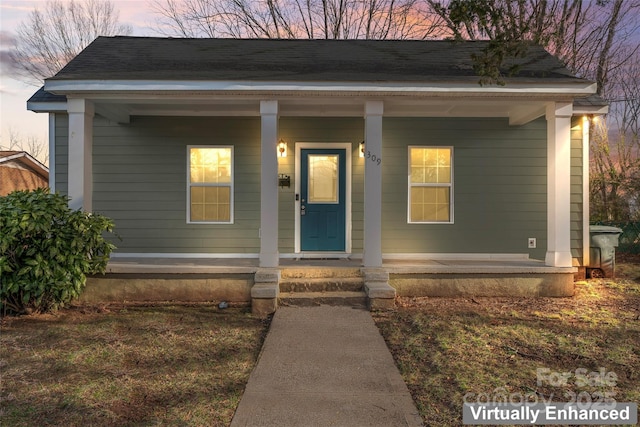 view of front of property with covered porch and roof with shingles