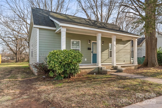 bungalow-style home with covered porch and a shingled roof