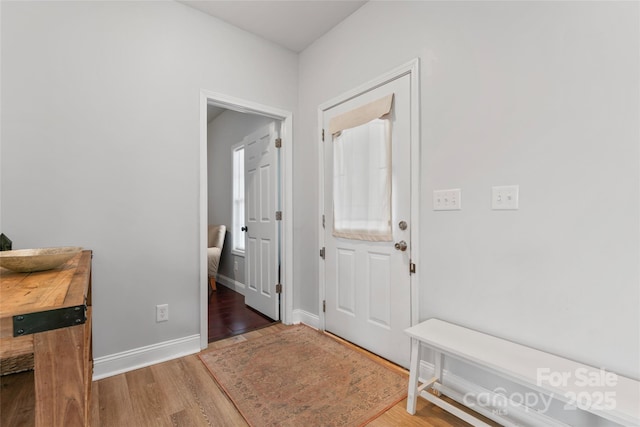 entrance foyer with baseboards and wood finished floors