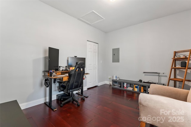 office space with attic access, electric panel, dark wood finished floors, and baseboards