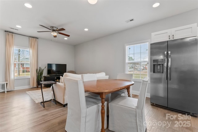 dining space with light wood-style floors, visible vents, a wealth of natural light, and recessed lighting