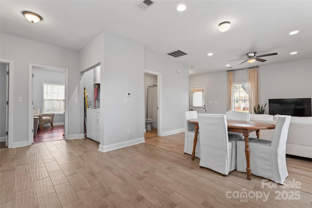 dining space with visible vents, plenty of natural light, and light wood finished floors