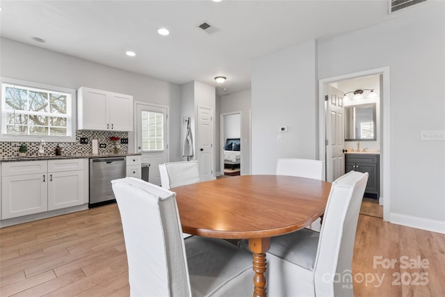 dining space featuring light wood-type flooring, visible vents, and recessed lighting