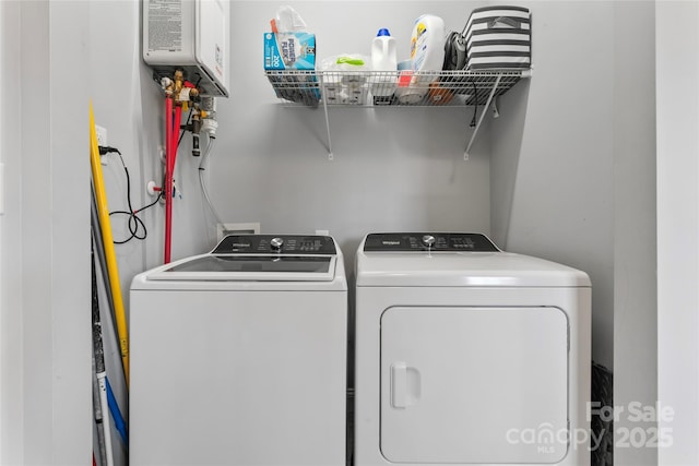 laundry room featuring water heater and washing machine and dryer