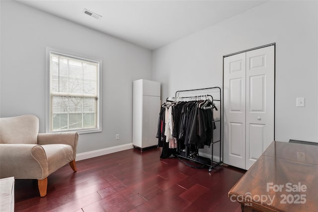 interior space with visible vents, baseboards, and dark wood-style flooring