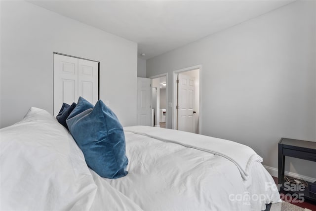 bedroom featuring baseboards and a closet