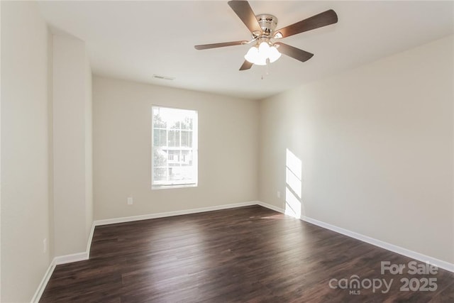 empty room featuring ceiling fan and dark hardwood / wood-style floors