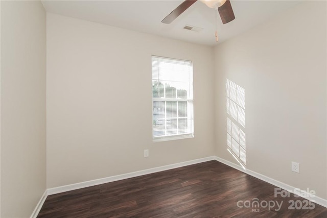 empty room featuring ceiling fan and dark hardwood / wood-style flooring