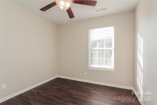 empty room with dark hardwood / wood-style floors and ceiling fan