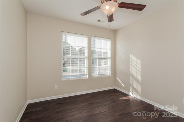 spare room with dark hardwood / wood-style floors and ceiling fan