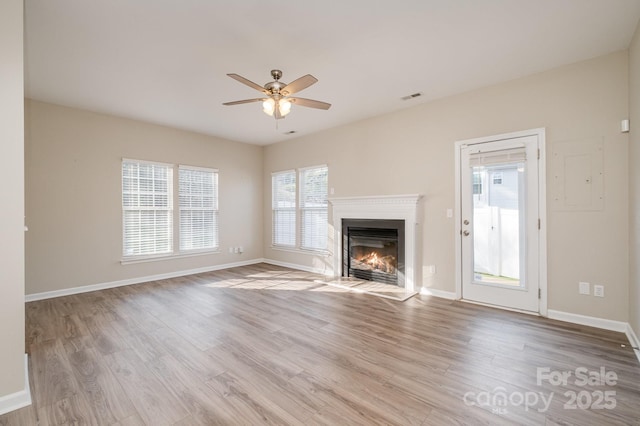 unfurnished living room featuring ceiling fan and light wood-type flooring