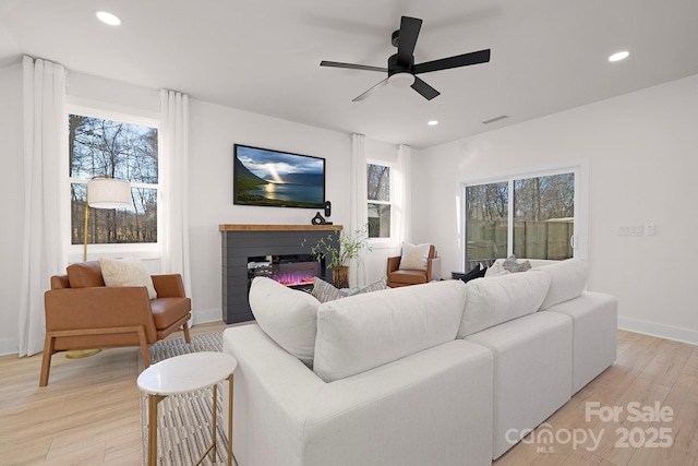 living room featuring ceiling fan and light wood-type flooring