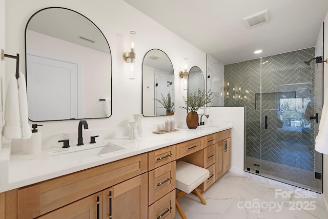 bathroom with vanity and a shower with door