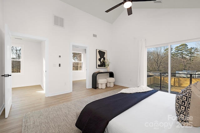 bedroom with ceiling fan, high vaulted ceiling, light hardwood / wood-style flooring, and access to outside