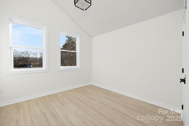 empty room with lofted ceiling and light hardwood / wood-style flooring