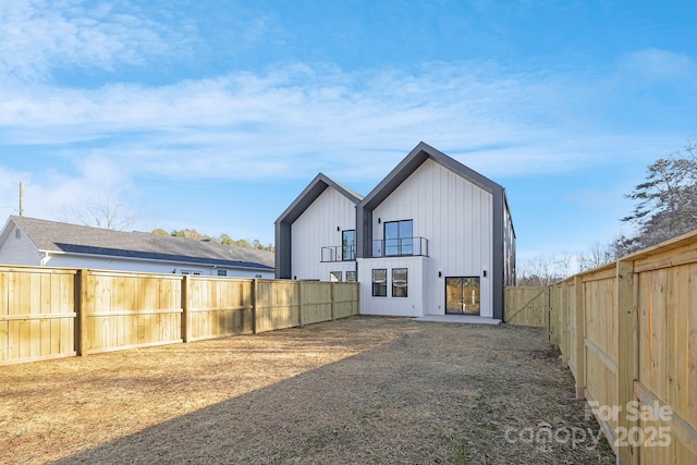 back of property with a balcony