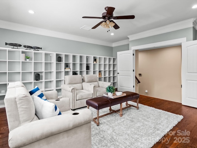 living area with dark wood-type flooring, recessed lighting, ornamental molding, and a ceiling fan