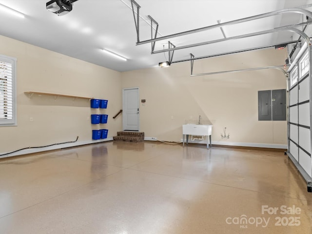 garage featuring sink, a garage door opener, and electric panel