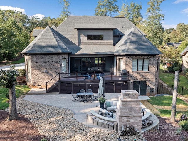 rear view of property featuring a patio, brick siding, crawl space, and fence