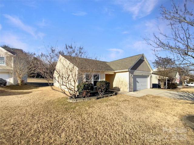 view of front facade with a garage and a front lawn