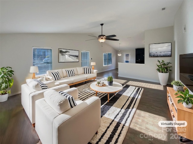 living room with dark wood-type flooring, vaulted ceiling, and ceiling fan