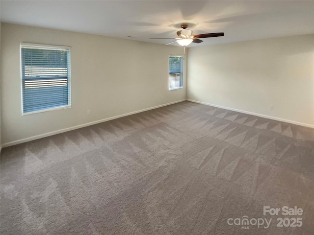 carpeted spare room with ceiling fan