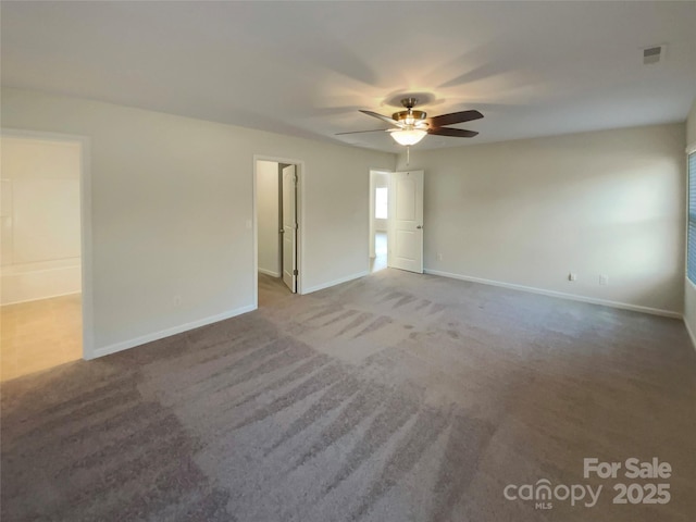 carpeted spare room with ceiling fan