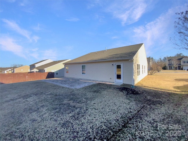 back of house featuring a patio area and a lawn