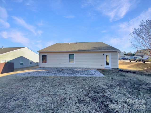 rear view of house with a yard and a patio