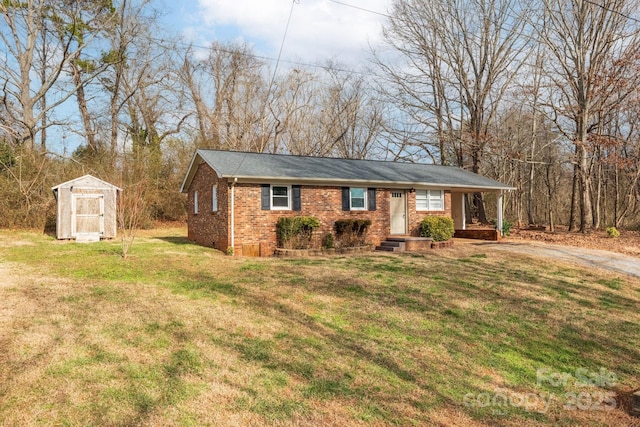 ranch-style home with a front lawn and a storage unit