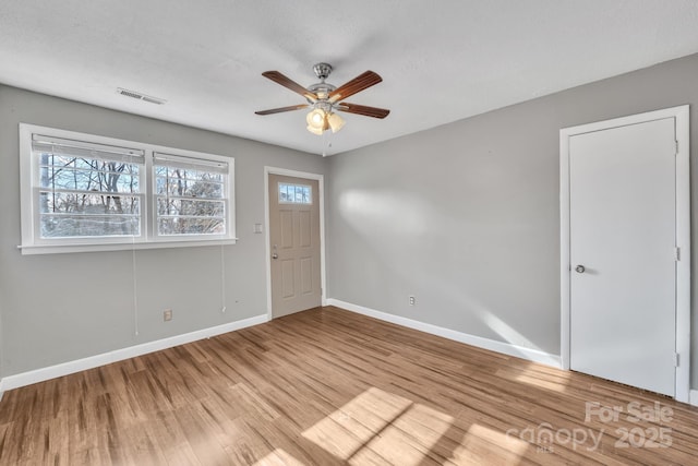 unfurnished room featuring ceiling fan and light wood-type flooring