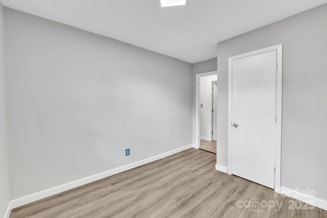 unfurnished bedroom with light wood-type flooring