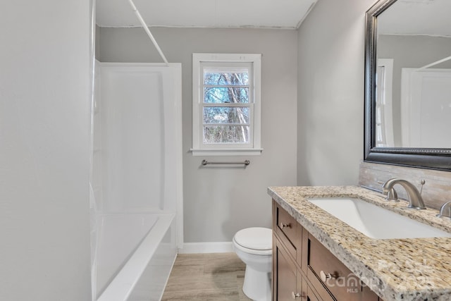 full bathroom featuring shower / tub combination, vanity, hardwood / wood-style floors, and toilet