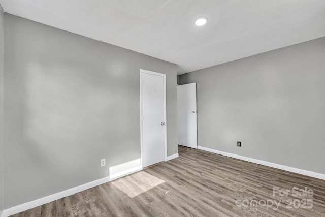 unfurnished room with light hardwood / wood-style floors