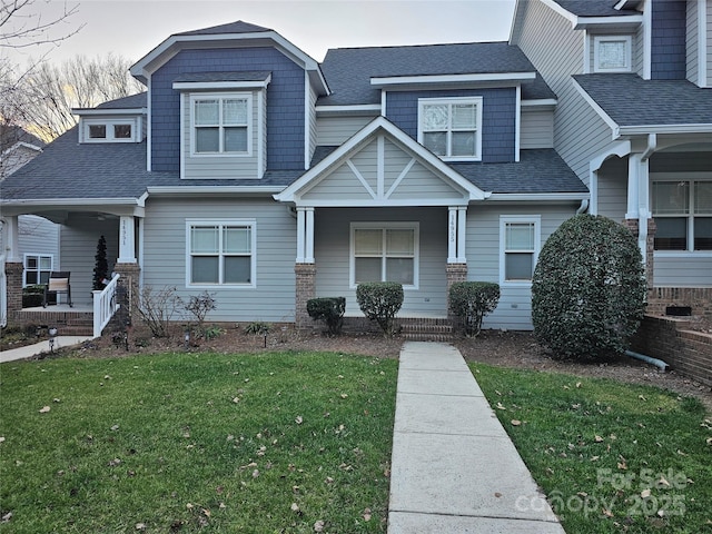 view of front of house with covered porch and a front yard