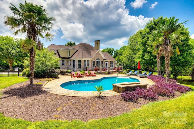 view of swimming pool featuring a patio area, fence, and a fenced in pool