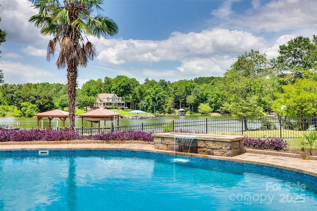 view of swimming pool with a gazebo, a water view, fence, and a fenced in pool