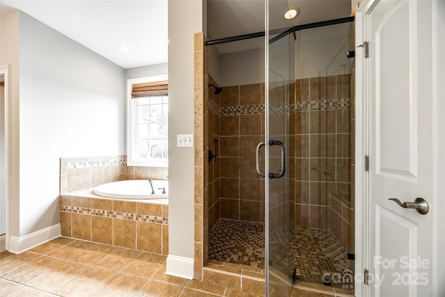 full bath featuring a stall shower, tile patterned flooring, and a bath