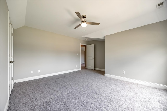 unfurnished room featuring lofted ceiling, a ceiling fan, visible vents, baseboards, and carpet