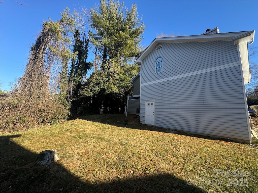 view of property exterior with a lawn