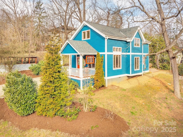 exterior space with crawl space, a front yard, and roof with shingles