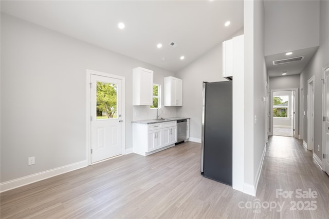 kitchen with sink, a wealth of natural light, stainless steel appliances, and white cabinets