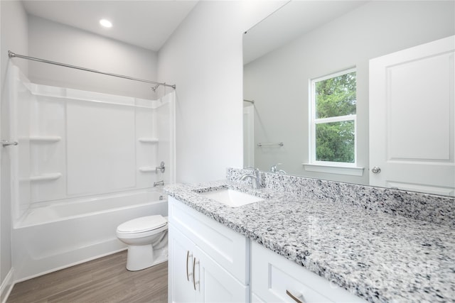 full bathroom featuring shower / bath combination, wood-type flooring, vanity, and toilet