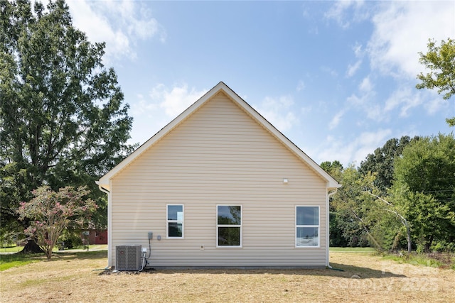 view of home's exterior featuring a yard and central air condition unit