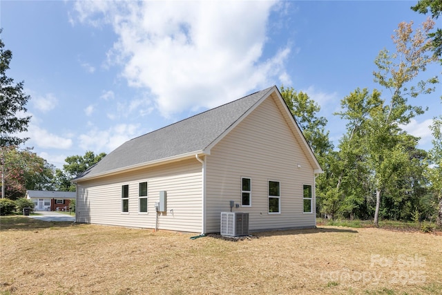 view of home's exterior featuring a yard and central AC