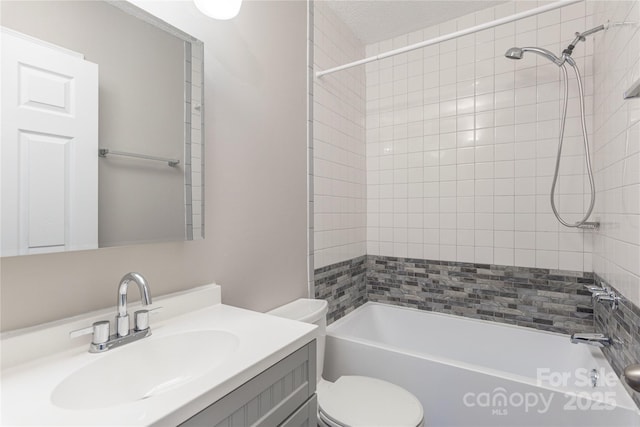 full bathroom featuring washtub / shower combination, vanity, and toilet