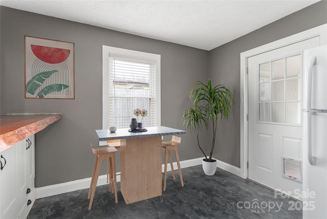 office featuring a textured ceiling and baseboards